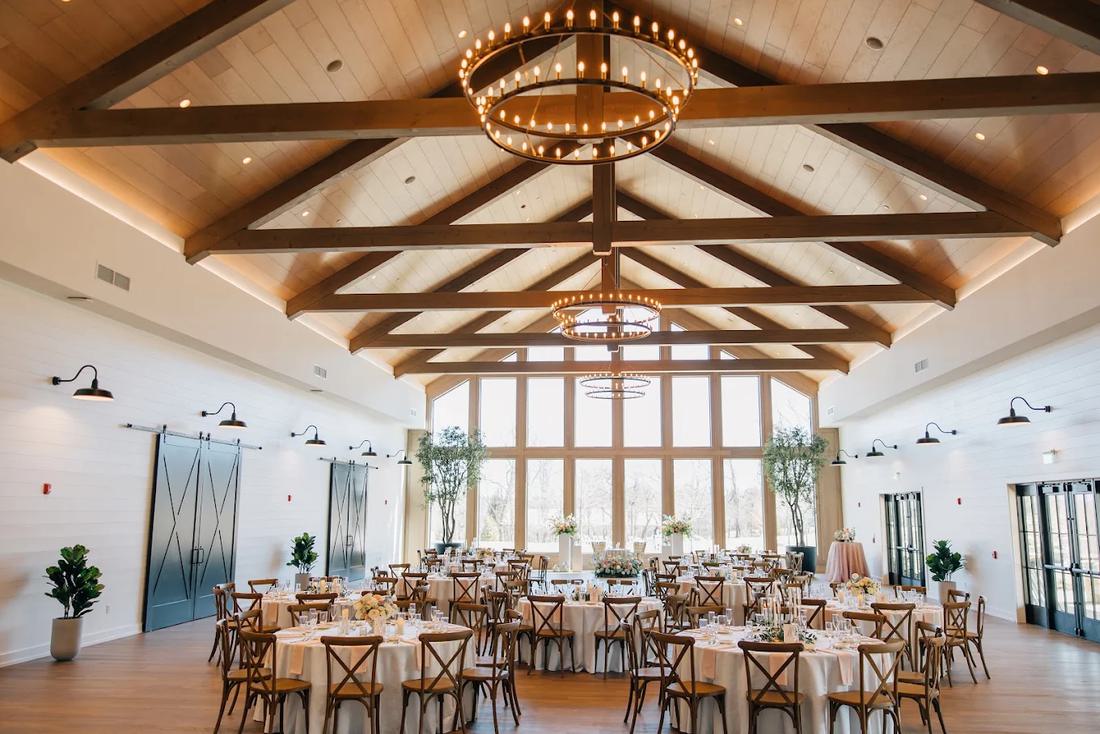 The main hall at Westwynd Gardens, set for dinner under timber beams